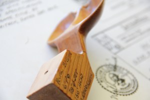 Hand carved pelton wheel with specifications.